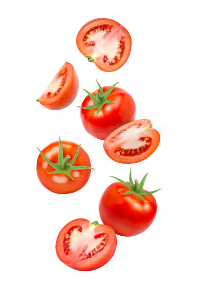 istock tomato with cut sliced flying in the air isolated on white 1419573685
