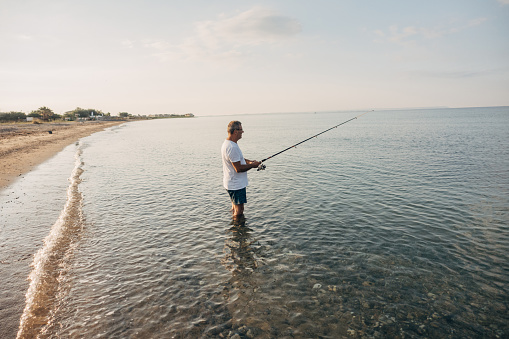 A fisherman uses a fishing rod