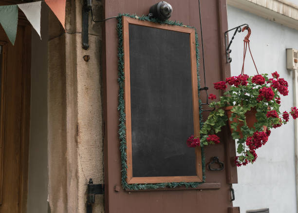 istock Empty street cafe menu in wooden frame hanging on wall outside 1419576247