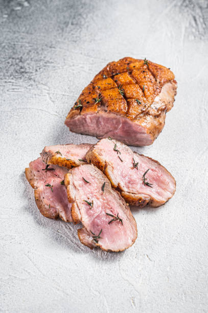 Roasted Sliced Duck breast fiilet steak. White background. Top view