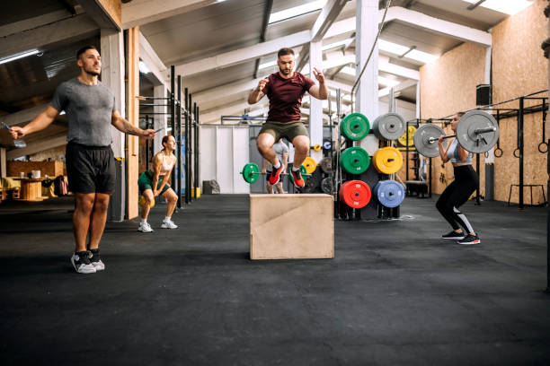 High intensity training method in group Group of athletes working out together in a gym circuit training stock pictures, royalty-free photos & images