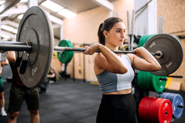 istock Female working out at gym with heavy weights 1419580505