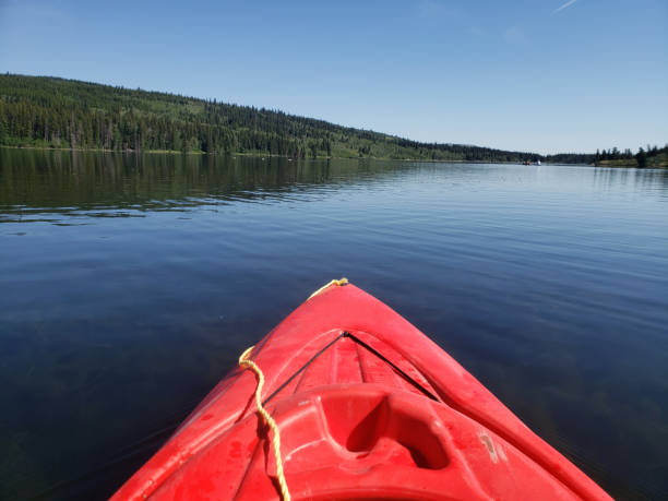 istock Bow of a red kayak floating on a lake 1419582969