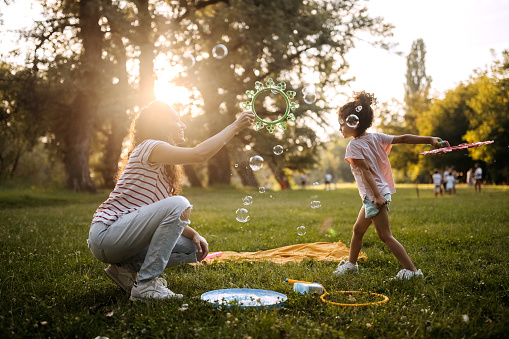 Mother and daughter having fun in a public park together