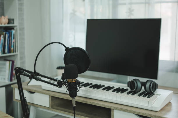 istock Home music studio condenser studio microphone, piano and white headphone for mixing production song. Home studio recording equipment. Music instrument concept. 1419586361
