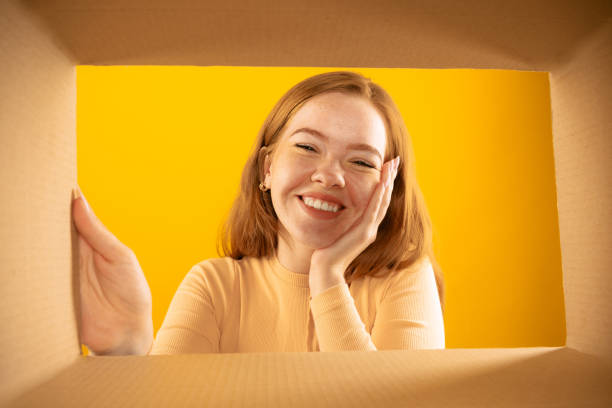 istock Happy smiling young girl looking inside box during opening, unpacking it. Emotions, black friday, holidays, online shopping concept 1419588850