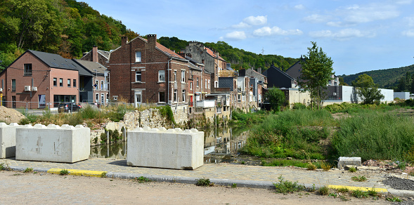 Pepinster, Province of Liège, Belgium - August, 30, 2022: view from  Walrand street bridge, after one year ago flooding ruined house along river Vesdre has been demolished by the municipality of Pepinster with budget of natural disasters