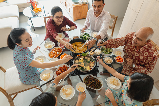 istock Chinese New Year - A multi racial and multi generation family come together for a reunion lunch 1419593064