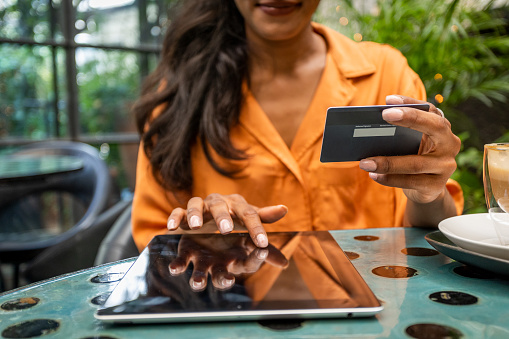 Young woman using digital tablet and credit card for online shopping