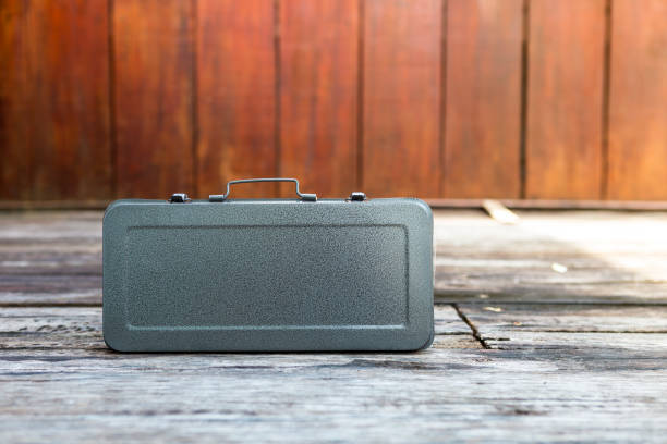 Metal tool box with space on wood background, simple design grey tool box