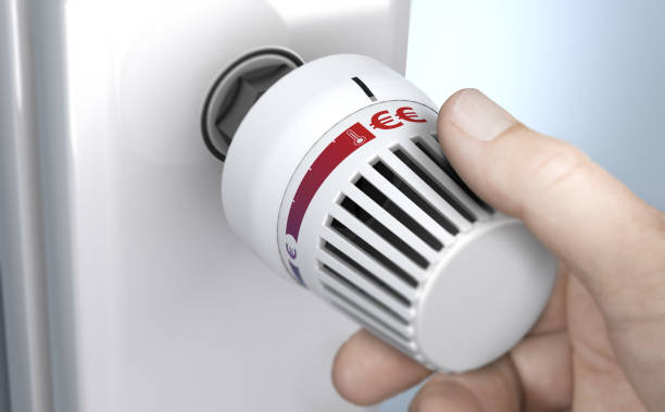 istock Man setting thermostat temperature to the higher position 1419595966