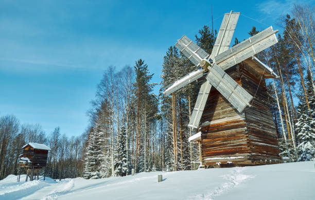 Old mill on a background of blue sky and trees. Background