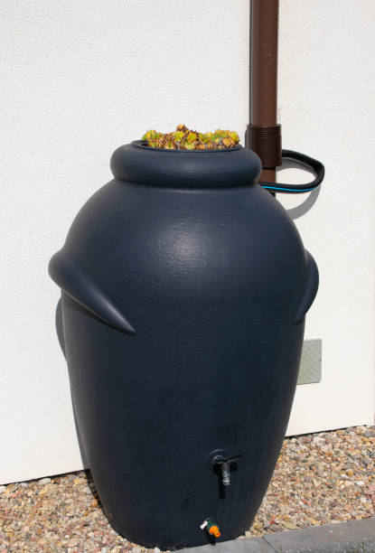 istock Rainwater barrel connected to the gutter, water saving concept 1419596221