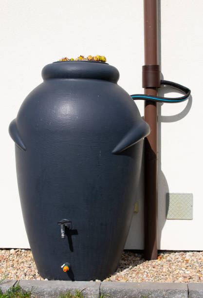 istock Rainwater barrel connected to the gutter, water saving concept 1419596230