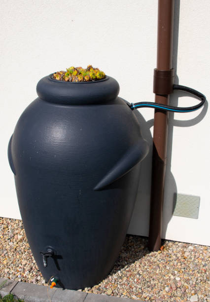 istock Rainwater barrel connected to the gutter, water saving concept 1419596241