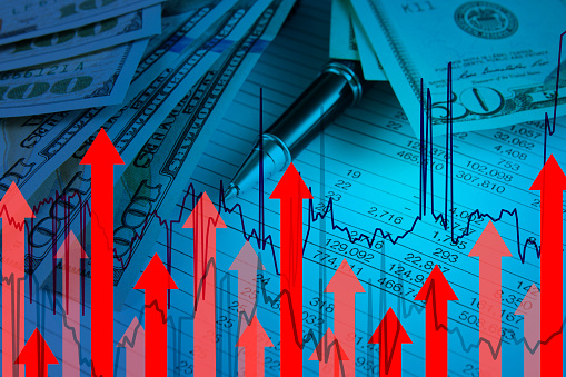 Inflation concept with one hundred American dollar bill with red finance graph and moving up arrows