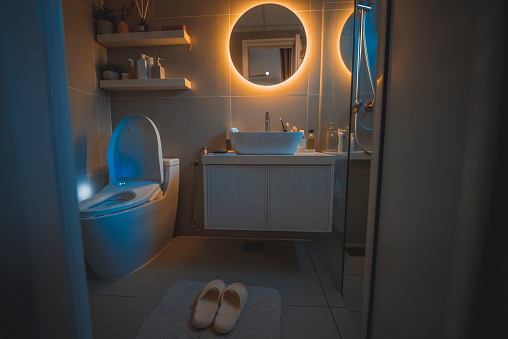 warm light cozy Interior of bathroom with mirror reflection and sink basin
