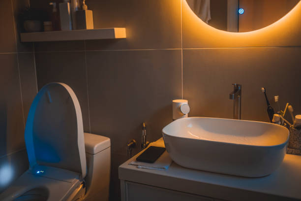 istock warm light cozy Interior of bathroom with mirror reflection and sink basin 1419601362