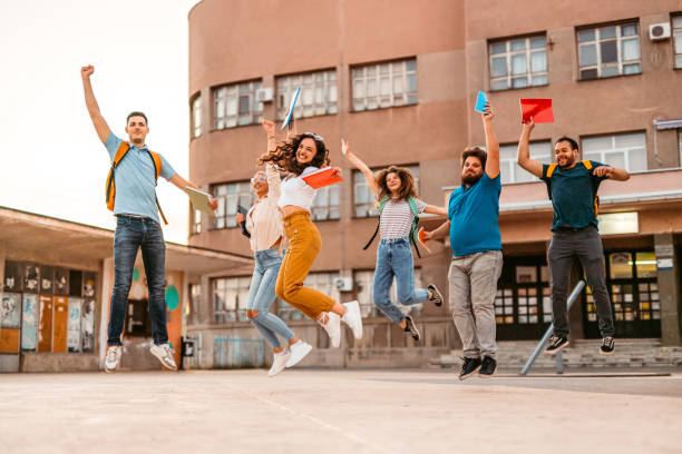 istock Group of Students Jumping Of Joy On The University Campus 1419602836