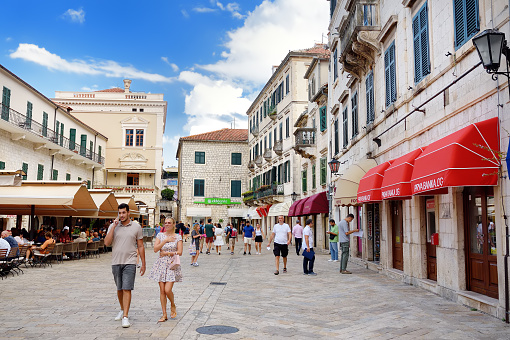 Kotor, Montenegro - August 23, 2022: Tourists on square at Kotor's Old Town. Tourism, travel, sightseeing of Montenegro.