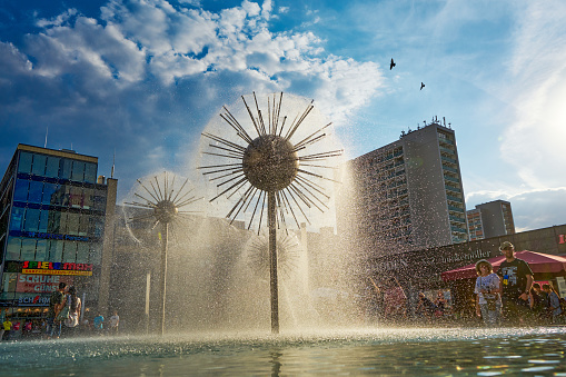 08/09/2022, Dresden, Germany: View of the Dandelion Fountain in the historic city center in summer. A place to relax in hot weather for tourists and city dwellers.
