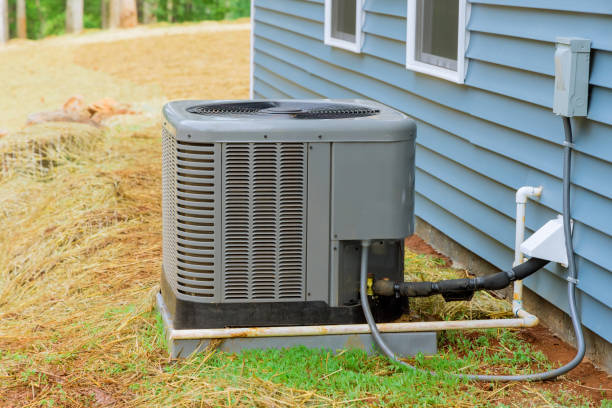 Installation of air conditioner near a new house stock photo