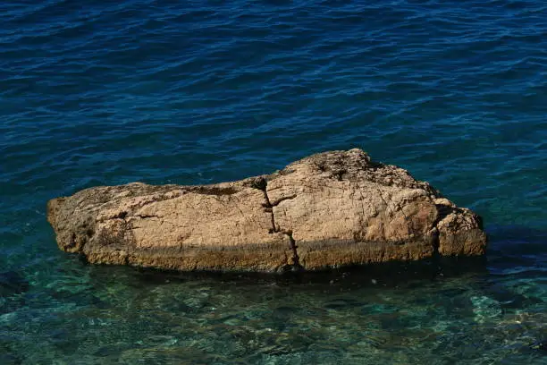 A rock protruding from the Adriatic Sea in Croatia