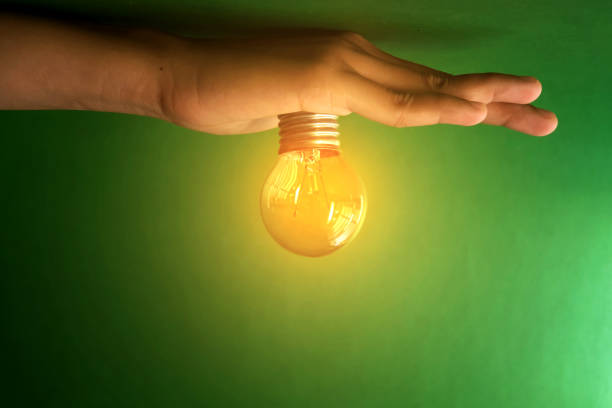 istock Glowing light bulb and innovation thinking creative concept in female hand 1419617973