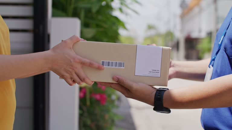 woman receiving a paper bag delivered at the front door