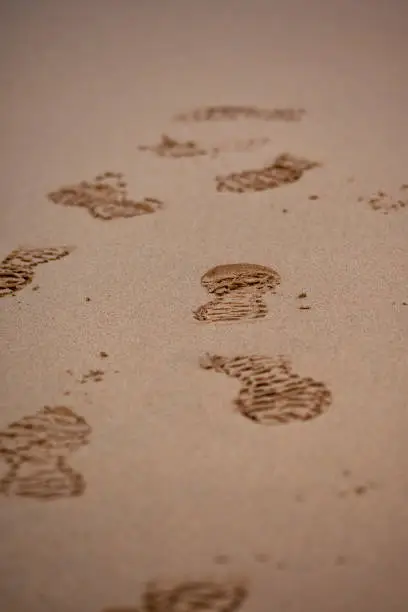 Trail running shoes printed in the sand