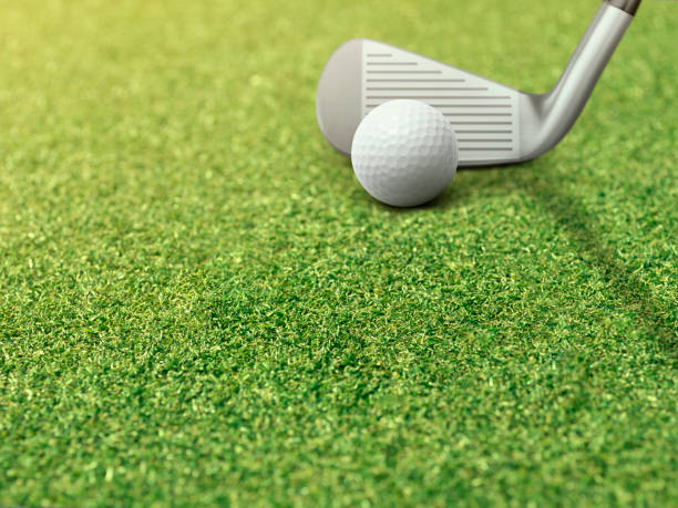 istock Golf ball and putter is on green grass next to golf hole 1419622552