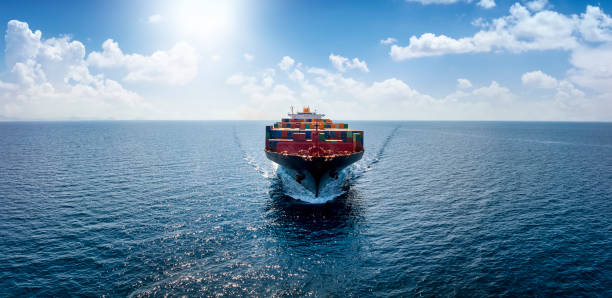 istock Front view of a container cargo vessel traveling over the ocean with copy space 1419625403