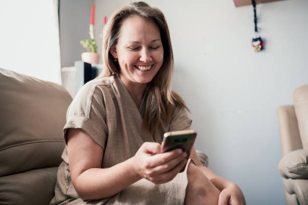istock Happy Woman Checking Her Earnings Online Using Smart Phone, Trading And Cryptocurrency Concept 1419626304