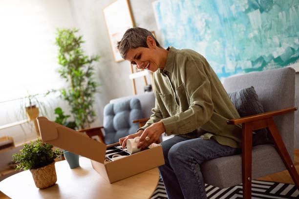 istock Woman unpacking her online order 1419628175