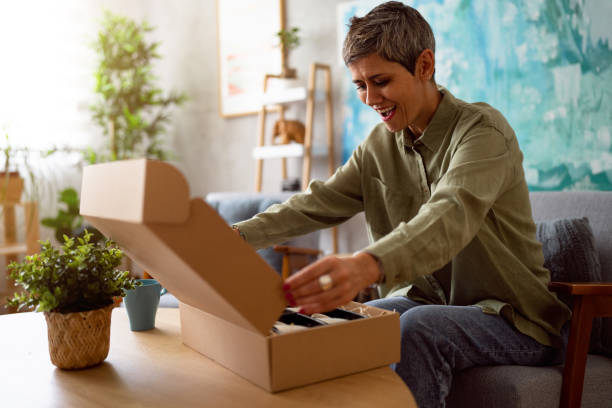 istock Woman unpacking her online order 1419628233