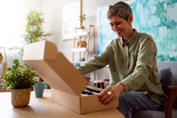 istock Woman unpacking her online order 1419628274