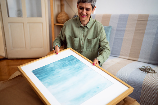 Woman unpacking the painting she ordered online.