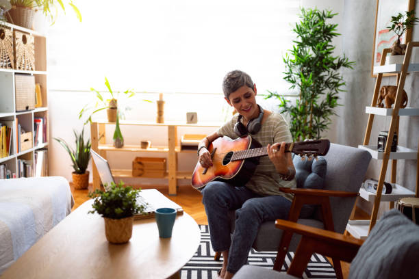 istock Woman taking online guitar lessons 1419630393