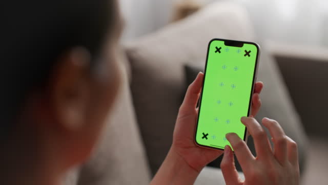 Woman using smart phone with green screen