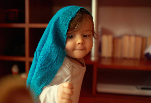 Little cute girl captured while wearing a towel on her head. She looks adorable.
