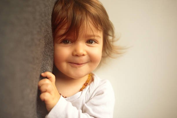 istock Adorable girl making a funny face looking in the camera 1419635169