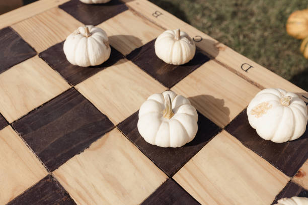 istock Halloween pumpkins on chess board, fall decoration 1419635753