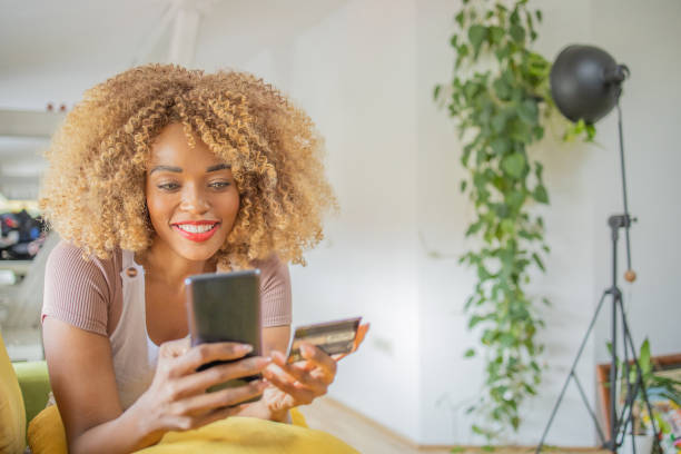 istock Cheerful  woman doing online shopping 1419637723