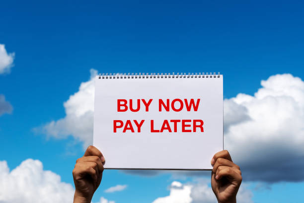 istock Hands holding placard with text Buy now pay later 1419638952