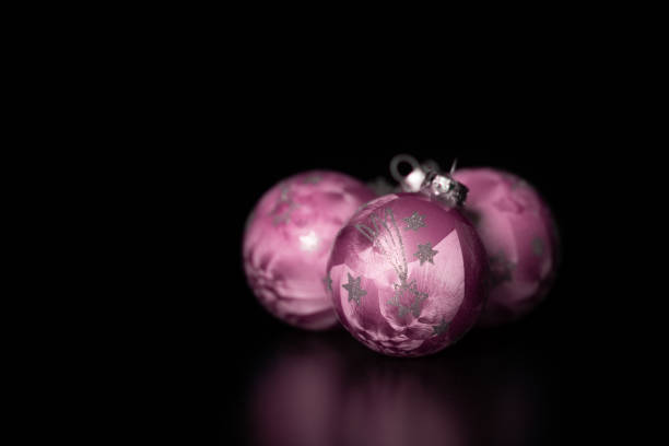 Pink Christmas tree balls on black background