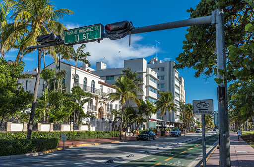 USA. Miami Beach.10.30.2023. Close up view of tree-shaped statue with lock, set against backdrop of charming buildings on Collins Avenue in Miami Beach.