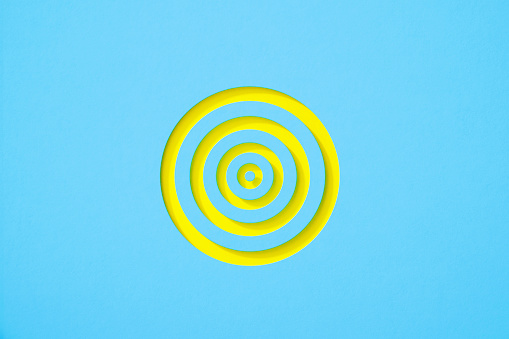 Yellow target on blue background. Horizontal composition with copy space.