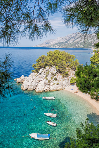 Amazing beach with boats against azure sea in Brela, Makarska, Dalmatia, Croatian coast