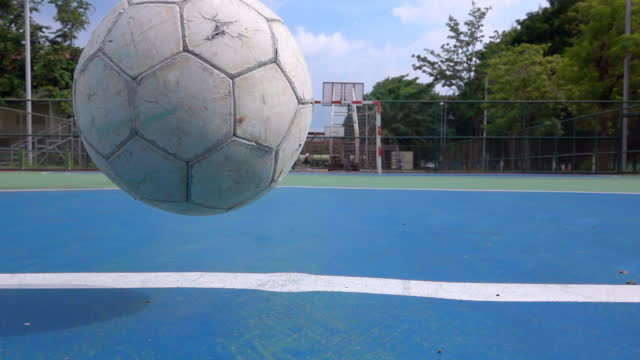 Old Soccer Ball Bouncing On Soccer Pitch Slow Motion