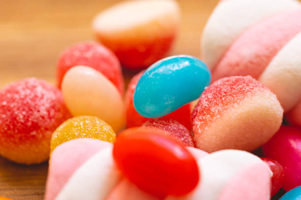 Candy background.Bright candies on a blue background.Flat lay.